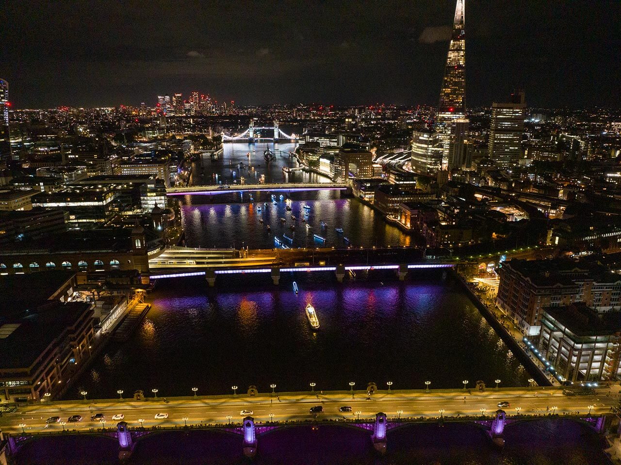 reflections flotilla river thames illuminated bridges